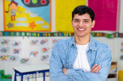 Male Teacher standing in a classroom