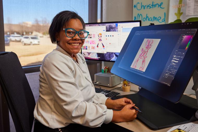 Student sitting at digital art workstation