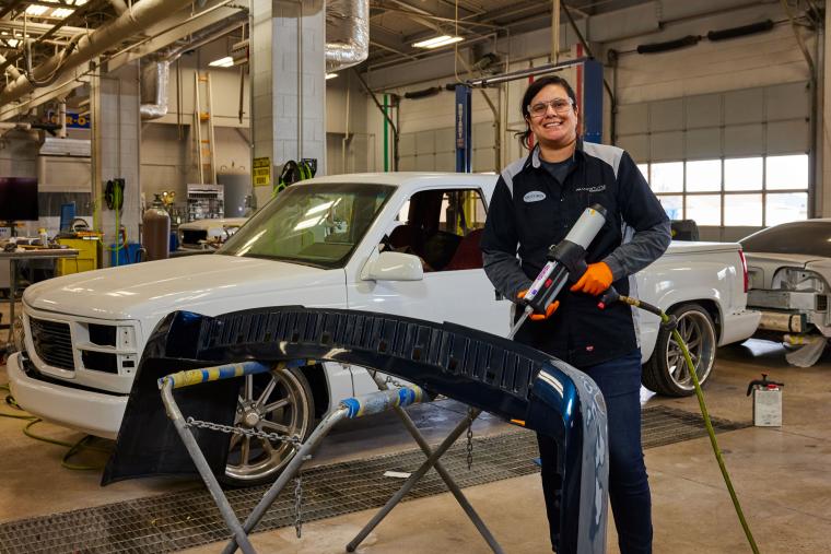 Student standing in front of pickup truck