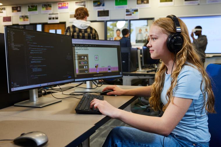Student writing code for a video game