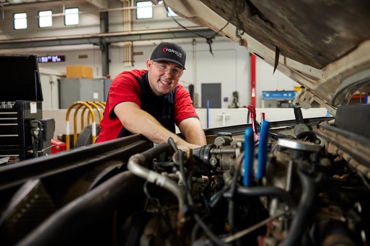 Student working on the inside of a semi truck