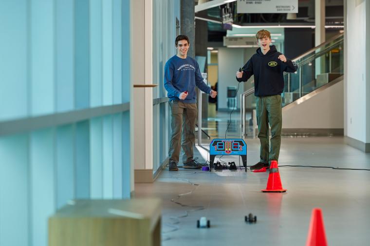 Two students racing small cars