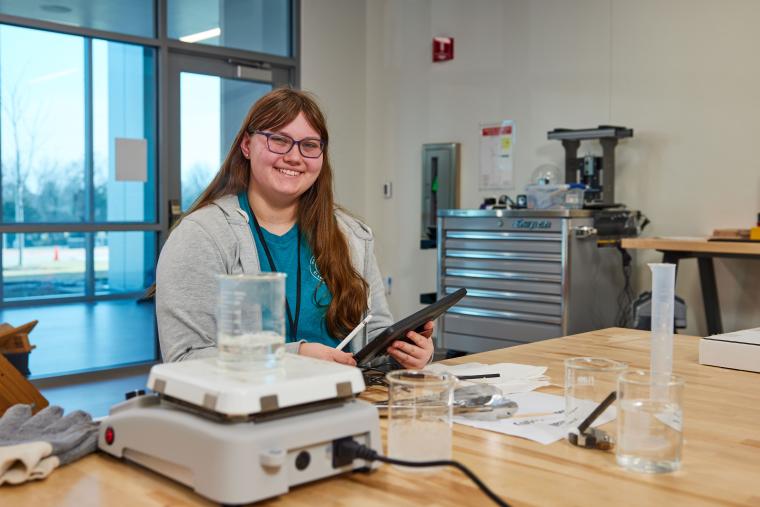 Student boiling a beaker of water on a hot plate