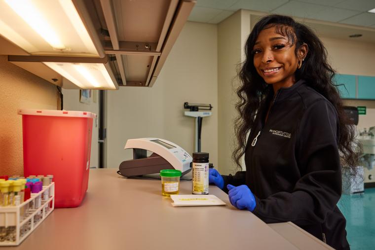 Student conducting urinalysis