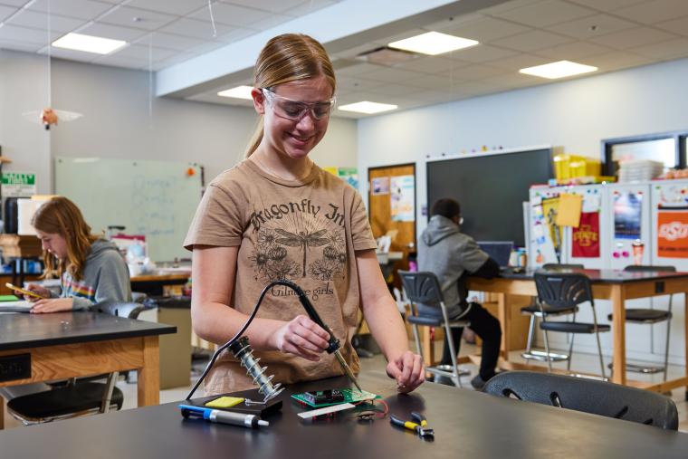 Student soldering circuit board