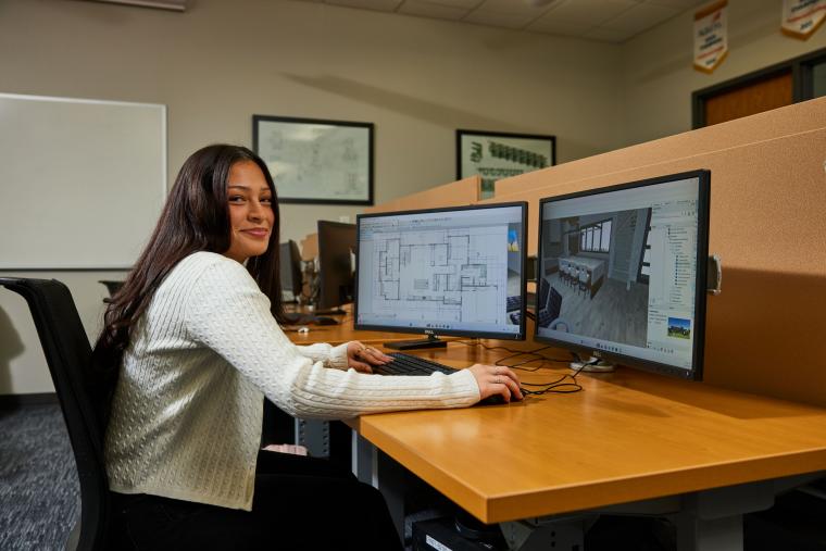 Student modeling building interior on a computer