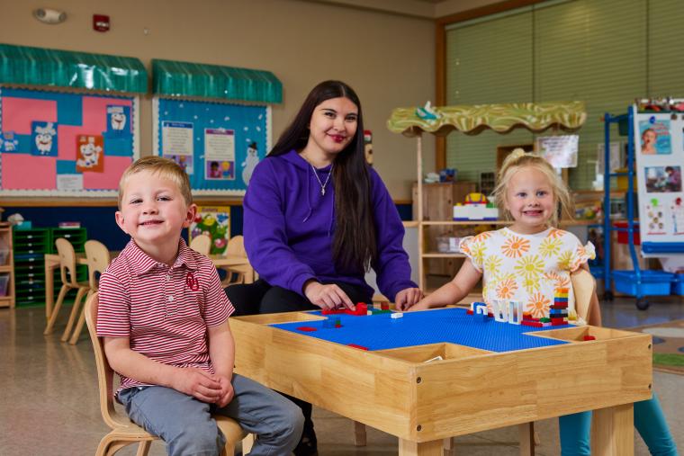 Student and two kids playing with legos