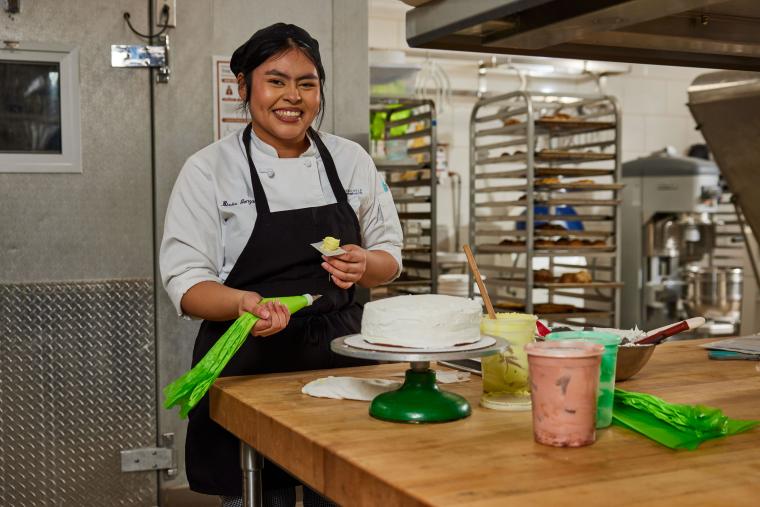 Student decorating a cake