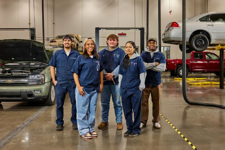 Several students standing together in the francis tuttle auto service workshop