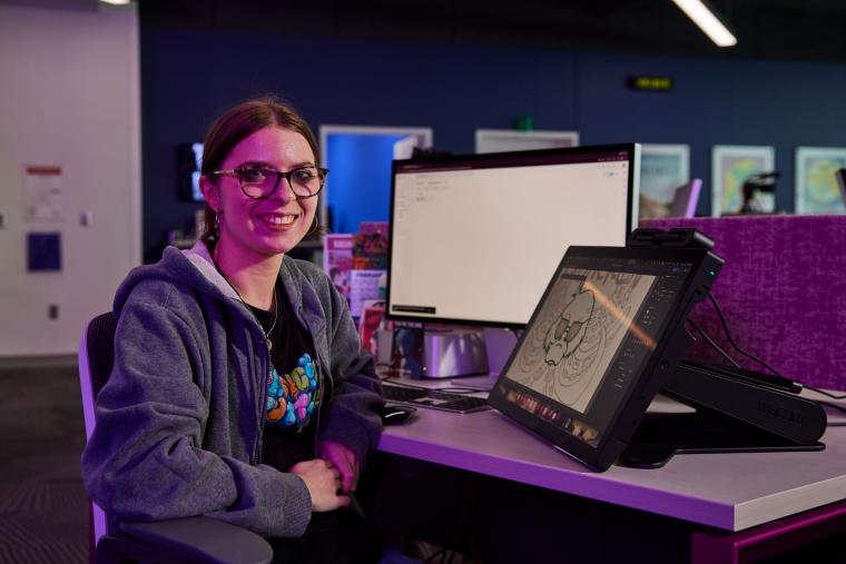 Student using a computer to draw a picture