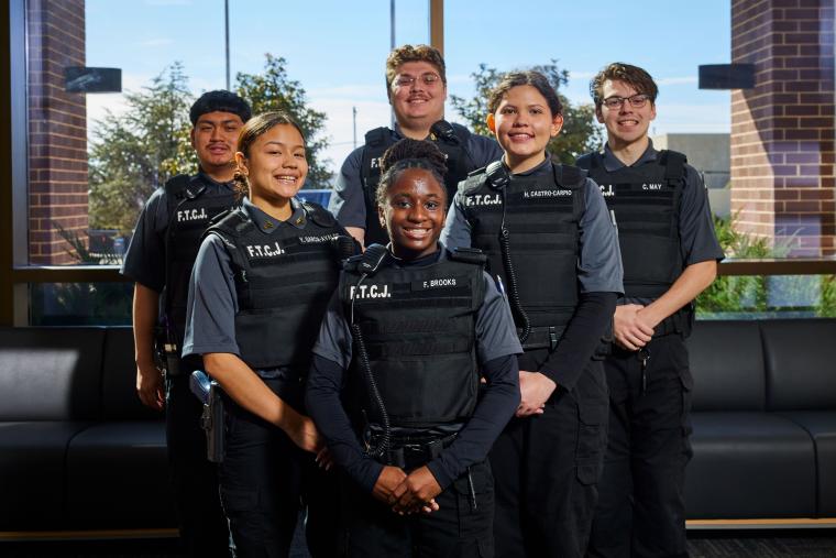 Several criminal justice students standing together in uniform
