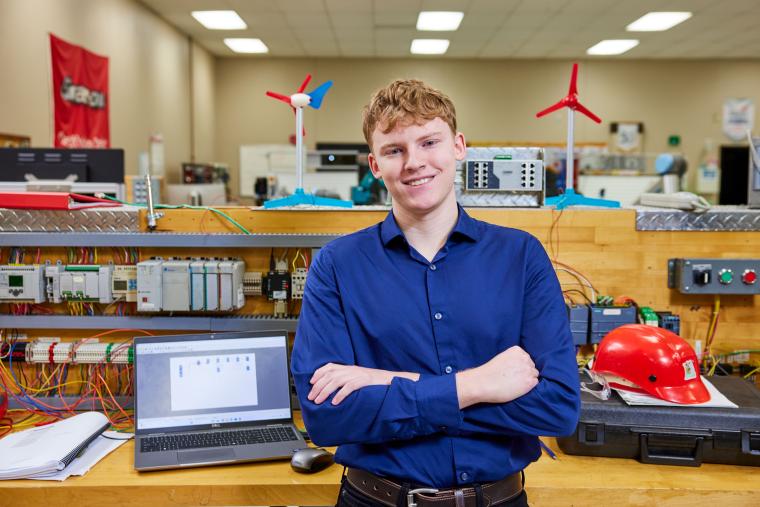 Student standing in front of workbench