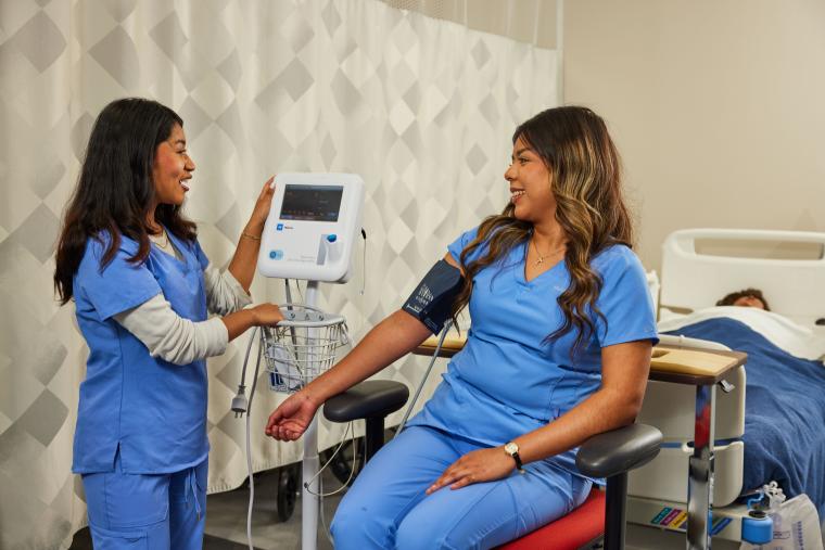 Student taking another student's blood pressure