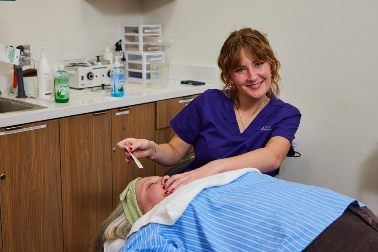 Student preparing customer for waxing