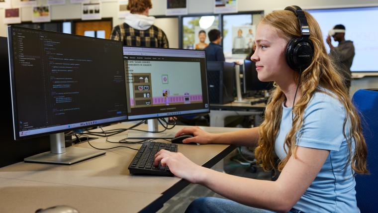 Student writing code for a video game