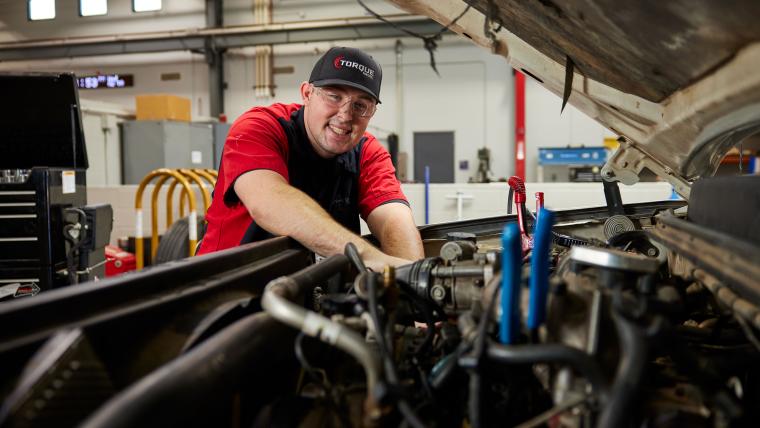 Student working on the inside of a semi truck