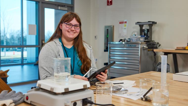 Student boiling a beaker of water on a hot plate