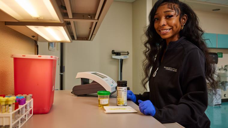 Student conducting urinalysis