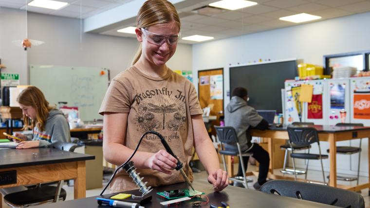Student soldering circuit board