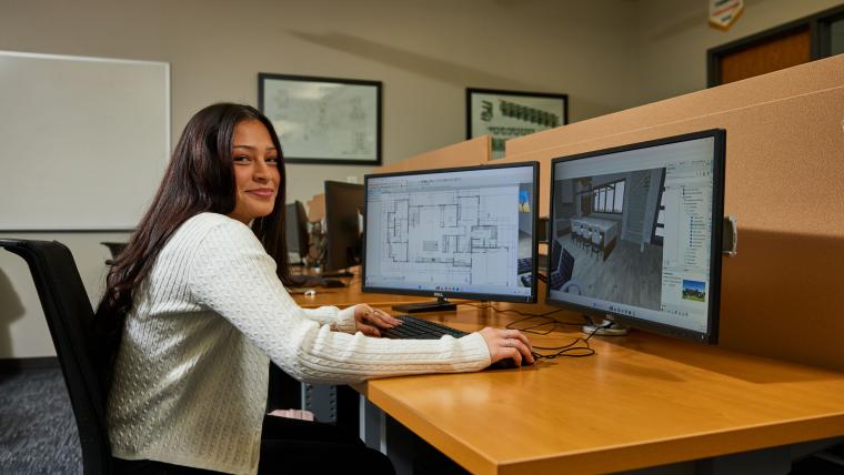 Student modeling building interior on a computer