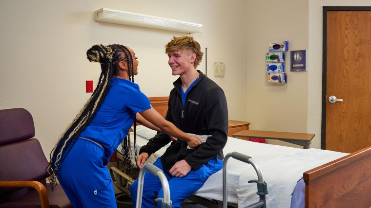 Student practicing helping a patient use a walker