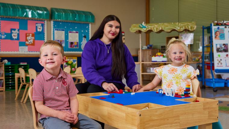 Student and two kids playing with legos
