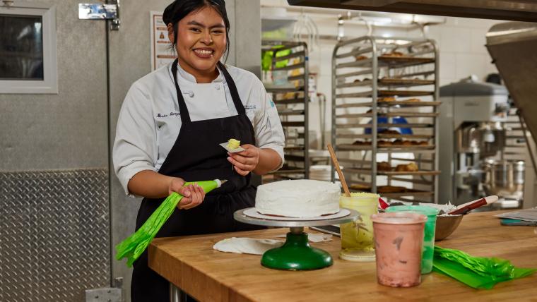 Student decorating a cake