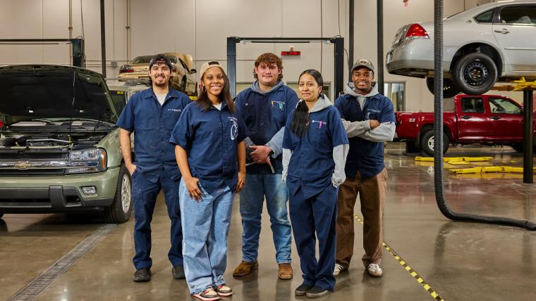 Several students standing together in the francis tuttle auto service workshop