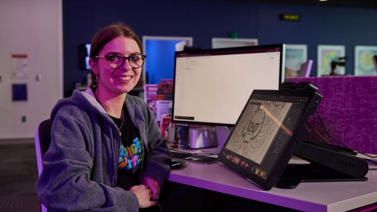 Student using a computer to draw a picture