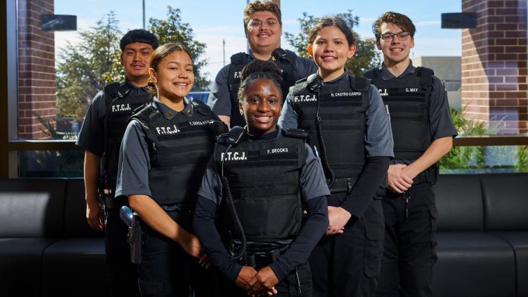 Several criminal justice students standing together in uniform