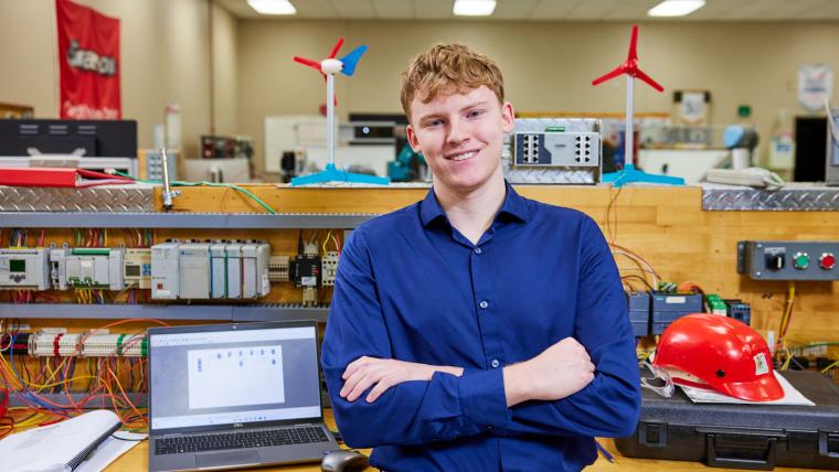 Student standing in front of workbench