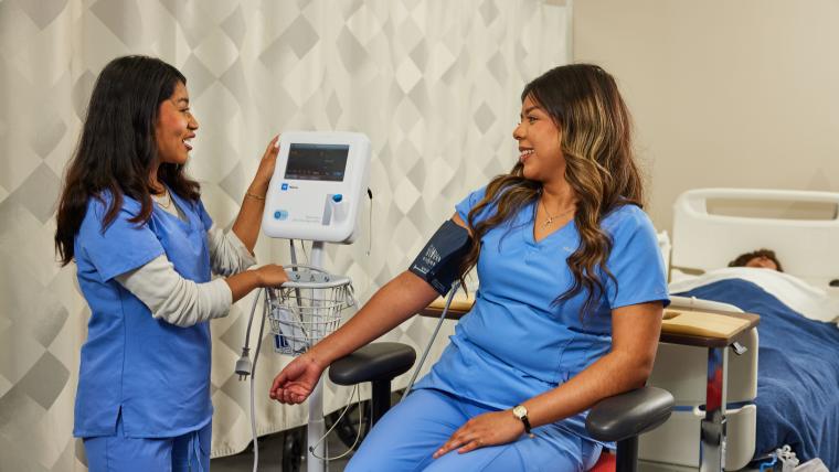 Student taking another student's blood pressure