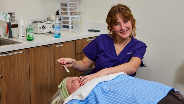 Student preparing customer for waxing