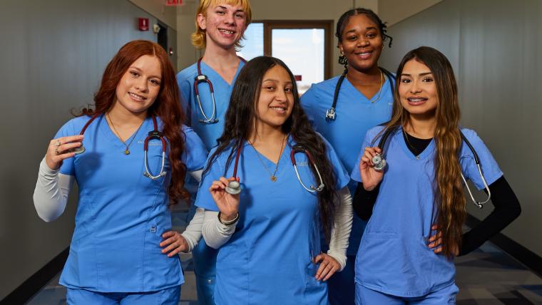 Several students standing together holding stethoscopes