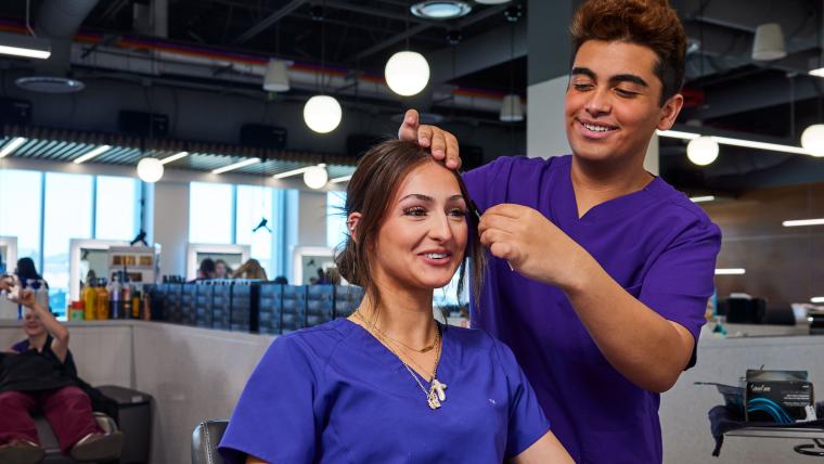 Student practicing combing another student's hair