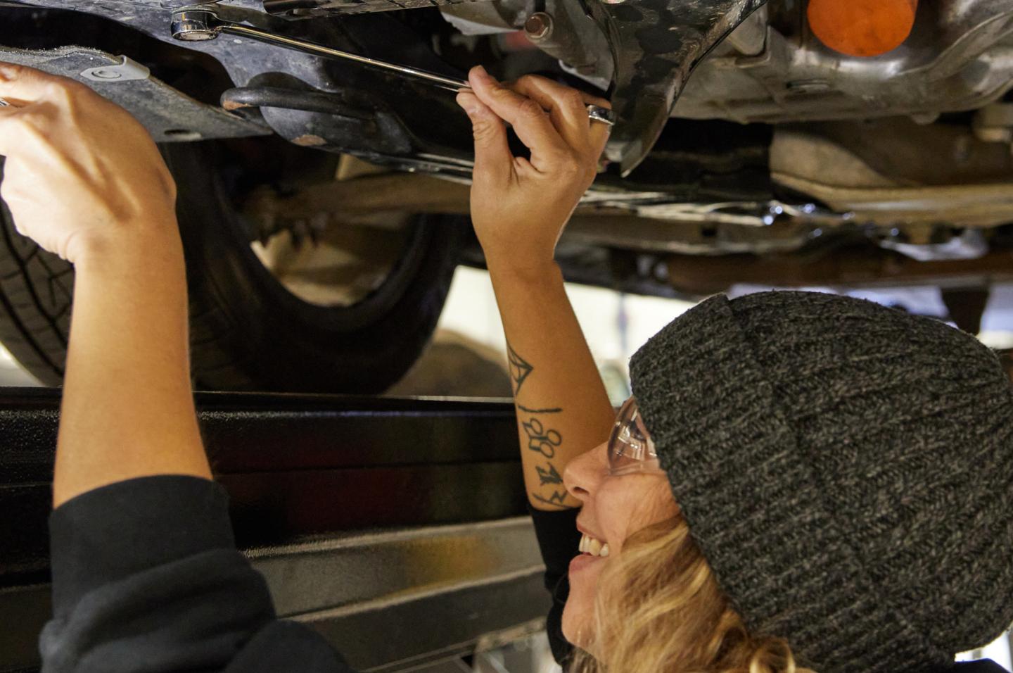 A student works on a car in the Automotive Service Technology Program