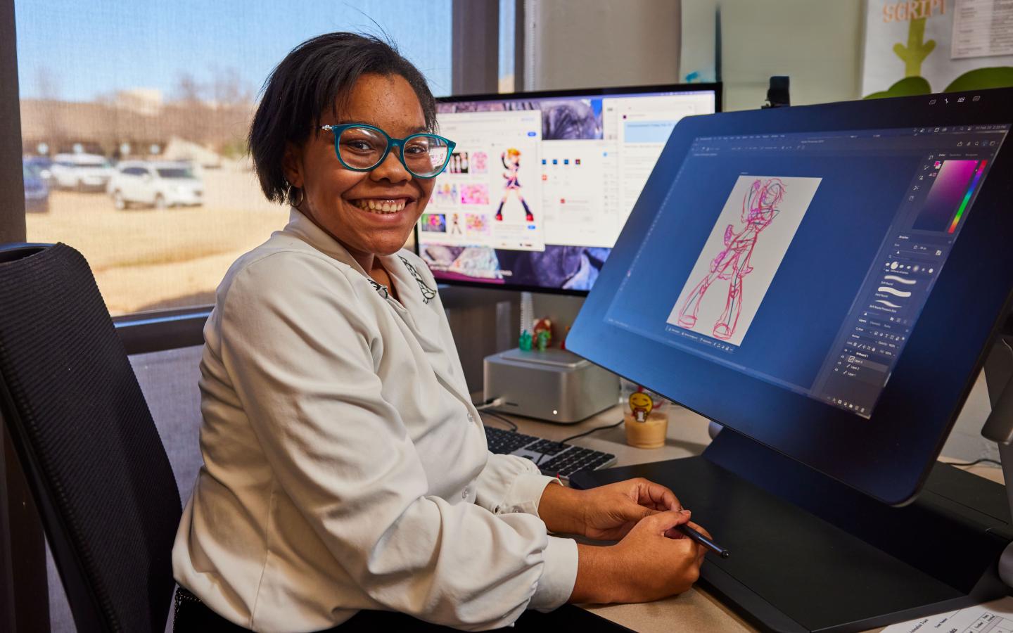 Female student sitting at a computer.