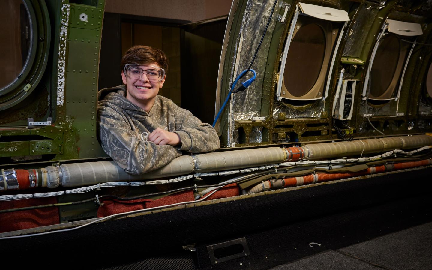 Student leaning into aircraft from outside
