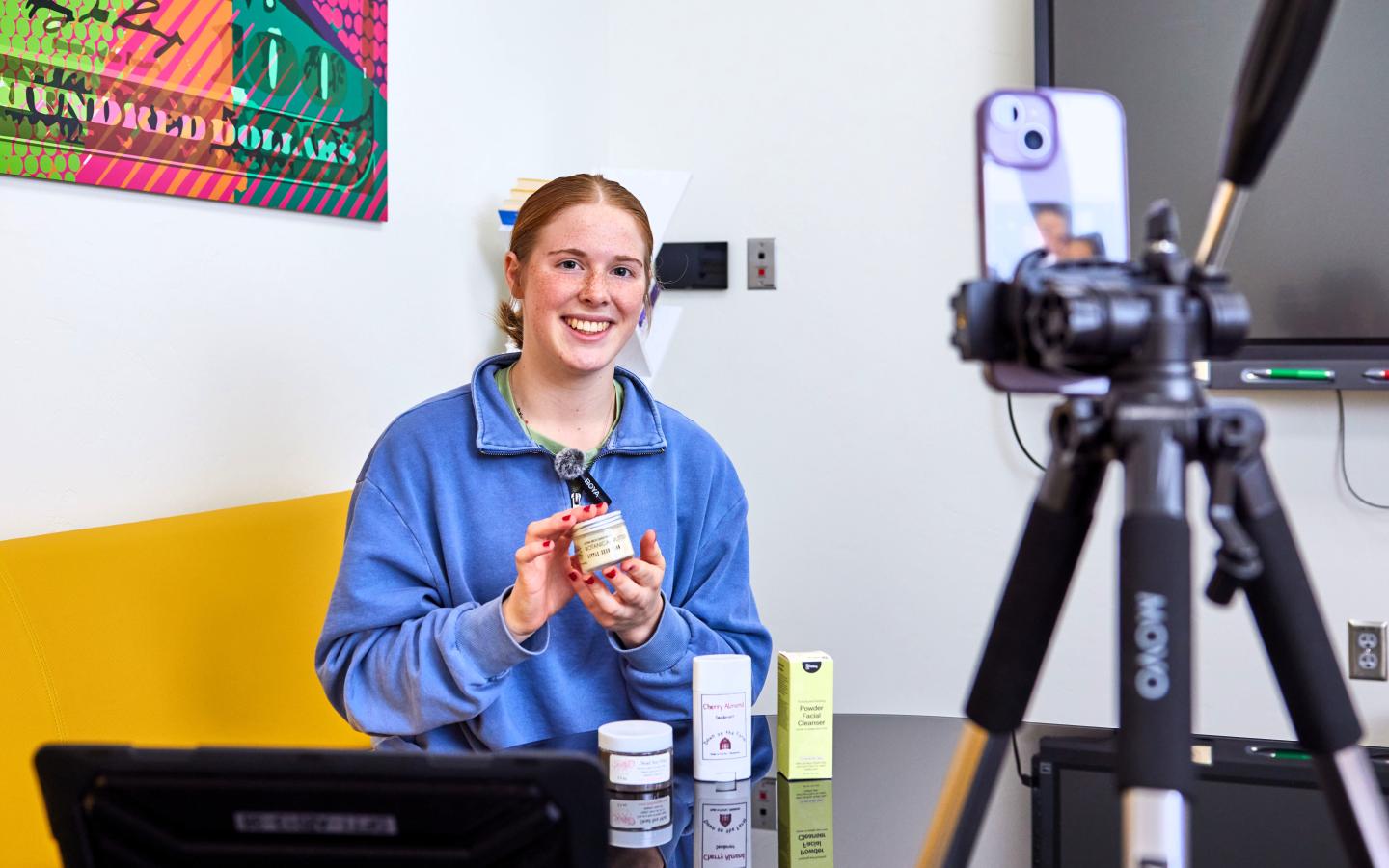 Female student showcasing her products.