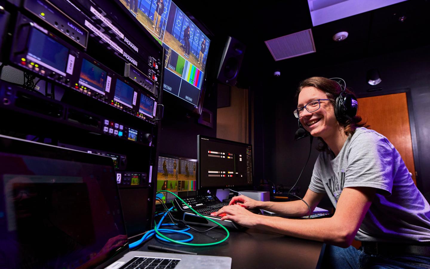 Male student working on tv production equipment.