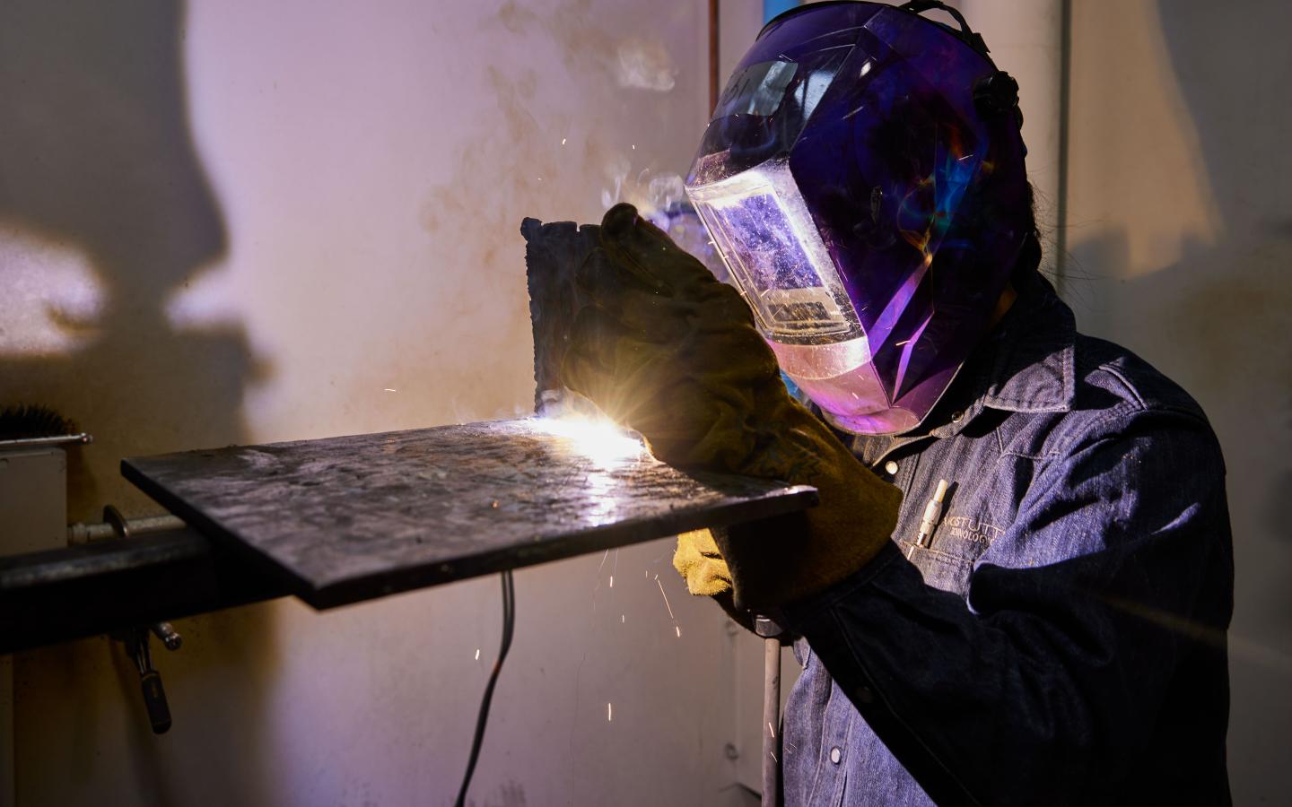 Female student practicing a weld.