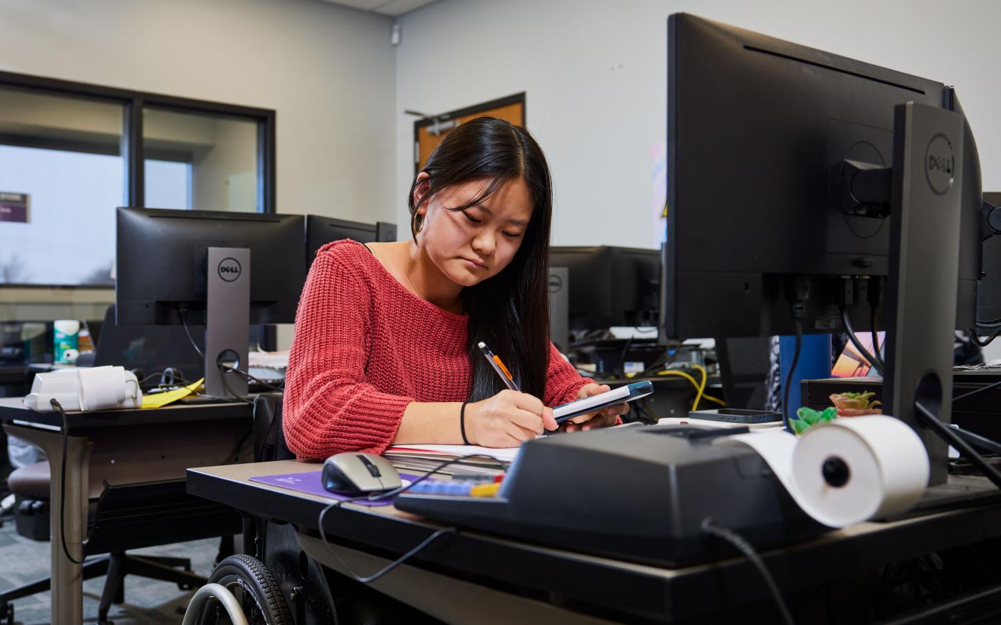 Female student working at a desk.