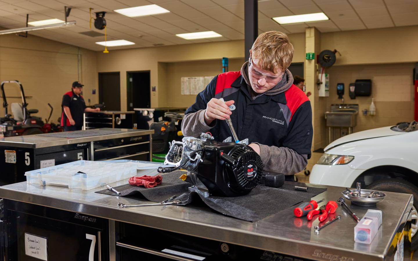 Male student working on a small engine.