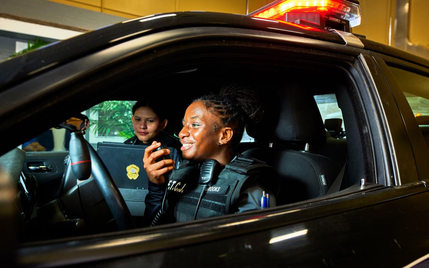 Female student in a police cruiser.