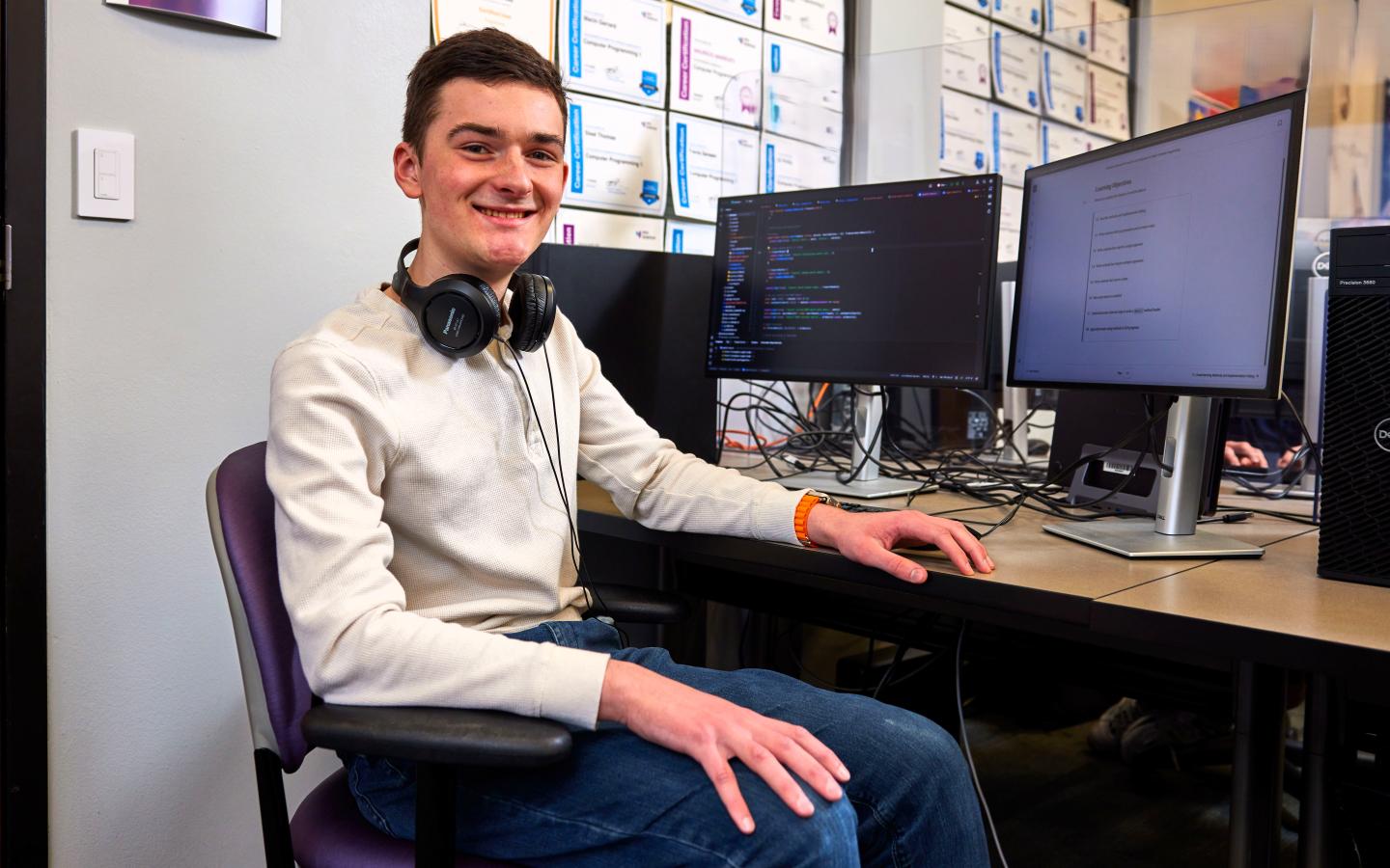 Programming student at a computer desk