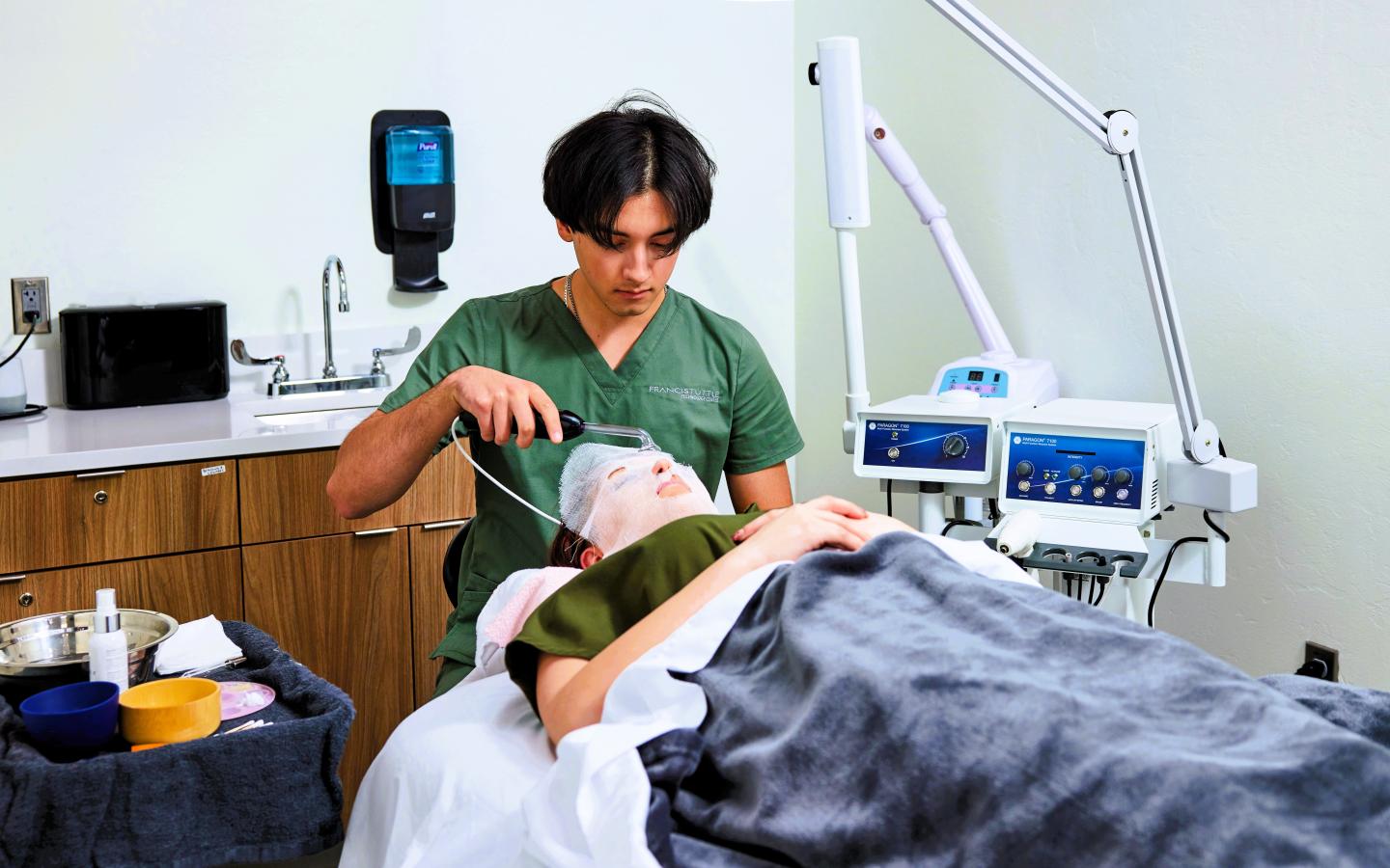 A male student giving a facial.